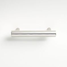 a chrome door handle on a white wall