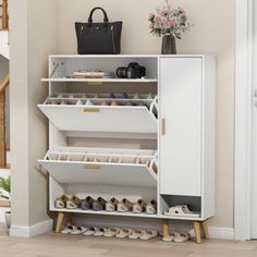 a white shoe rack with many pairs of shoes on it in front of a door