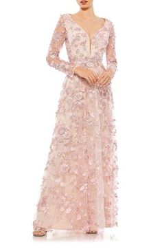 Fluttering flowers alight upon this delicately dreamy gown, fixed with sheer sleeves and a swishy skirt. Sweetheart neck with illusion lace panel Long sleeves Lined, except sleeves 100% polyester Spot clean Imported Asian Owned/Founded Mog Dresses, Illusion Gown, Dreamy Gowns, Formal Wedding Guest Dress, Mother Of The Bride Dresses Long, Bride Gown, Mother Of Groom Dresses, Sleeve Gown, Floral Gown