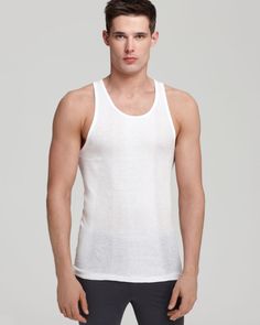 White Seamless Crew Neck Tank Top, Fitted Crew Neck Workout Vest, Fitted Crew Neck Tank Top For Loungewear, Ribbed Cotton Scoop Neck Tank Top, Stretch Ribbed Scoop Neck Vest, White Ribbed Scoop Neck Tank Top, White Scoop Neck Basic Tank Top, Fitted Vest Tank Top For Loungewear, Cotton Tank Top With Wide Straps