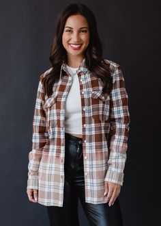 A flannel so good you'll want to wear it all season long! Our new brown, black, blue and white plaid flannel with bleached dipped contrast is an easy option to toss on while running errands. Brown, black, blue and white plaid flannel Bleached dipped contrast Button closure Slits on each side Designed in the U.S.A. Produced in India. Model is wearing a size small 100% Cotton SIZE CHART S: Bust: 38" / Length: 28" M: Bust: 40" / Length: 29" L: Bust: 42" / Length: 30" XL: Bust: 44" / Length: 31" Fall Flannel, Knit Hat For Men, Knitted Hats Kids, Flannel Outfits, Blouse Tank Top, Flannel Women, Sweaters Crewneck, Long Jumpsuits, White Plaid