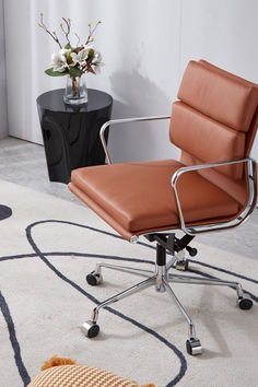 a brown office chair sitting on top of a white rug