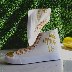 Golden or any other favorite Quinceañera color, you can modify the design. Quinceañera Hand-made Sneakers, for the celebration of a girl's 15th birthday, marking her passage from girlhood to womanhood. Make a statement with stunning decorated sneakers canvas, bedazzled with rhinestones, glitter, and other beautiful details. Make this spectacular gift as a real Queen Gift adding a tiara to your order :). See details below.  🌟Includes🌟 - Pick shoelace colors.  - The toe top is covered with bright rhinestones (mixing primary and secondary colors). - On the sides of the shoe (right & left), the idea/name/date is printed in solid or glitter color. - The back has the year printed. 🧡You will receive🧡 - One pair of sneaker canvas off-brand - One pair of delicate Silk laces - One special custom Decorated Sneakers, Quinceanera Shoes, Birthday Shoes, Queen Gifts, Primary And Secondary Colors, Secondary Colors, Party Dance, 15 Gifts, Blue Party