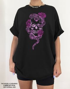 We are loving this skull skeleton vintage aesthetic tee. Its such a cute addition to any pastel goth clothing collection. It even gives romantic & soft goth vibes! We suggest going 1-2 sizes up from your normal size to get an oversized look like the photos. This cotton tee has the classic cotton look and feel and fits like a well-loved favorite. It's soft, cozy, and a great trendy addition to your wardrobe! Super soft cotton and excellent quality print makes you fall in love with it over and ove Gothic Short Sleeve T-shirt With Skull Print, Edgy Skull Print T-shirt For Alternative Fashion, Gothic Skull Print Crew Neck Top, Alternative Skull Print T-shirt For Halloween, Skull Print Graphic Tee For Alternative Fashion, Graphic Tee Tops With Skull Print For Alternative Fashion, Graphic Tee With Skull Print For Alternative Fashion, Alternative Style Skull Print T-shirt, Gothic Skull Print T-shirt For Halloween