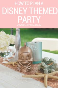 a table with candles, rocks and flowers on it that says how to plan a disney themed party