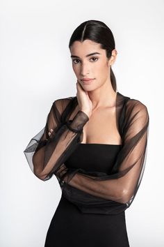 Light and airy, soft against the skin, our Olympia Bolero's sheer European mesh fabric will dance around your arms and shoulders. Her Juliette sleeves gather to a fitted cuff, while the boning in the back holds the piece perfectly in place. Regal and romantic, she's bound to be your best-kept evening wear secret.GET THE LOOKJacket: This ListingDress: https://etsy.me/2FwrfkqMODEL INFO: Sam is 5'8" (173 cm) tall. Wearing size XS.LENGTH: Approximately 13" (32 cm), measured from the shoulder to the Tulle Bolero, Shrug Dress, Mesh Shrug, Mesh Bolero, Shrugs And Boleros, Strapless Midi Dress, Black Tulle, Night Out Outfit, 80 Dress