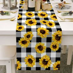 the table is set with sunflowers and wine bottles