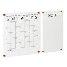 two white calendars with gold handles on each side and the words smtwtfs printed on them