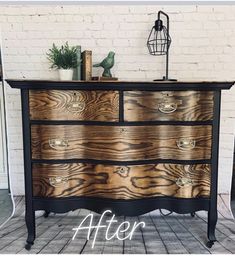 an old dresser has been painted with black paint and woodgrains to give it a new look