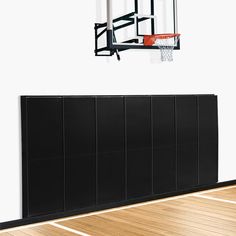 an empty basketball court with a basket hanging from the ceiling and a basketball hoop above it