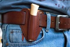 a man wearing a leather belt with a knife in his back pocket and a wooden mallet sticking out of it