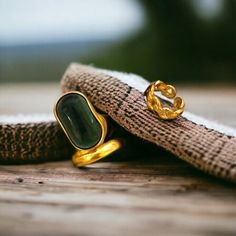 Elevate your style with our exquisite collection of vintage green stone rings. Our gold band and chain rings are perfect for adding a touch of glamour to any outfit. Whether you're looking for a statement piece or a charming gift, our women's jewelry will surely impress. Embrace the essence of streetwear fashion with our stocking ring set. Discover the perfect ring to make a fashionable statement. *Beautiful and charming sterling silver ring with a gold stone (925 stamped) *Adjustable *This ring is stylish and pretty ideal for everyday use. * Gender: Female *Ready to Ship in 1-2 Business Days * The product will be sent to you nicely packages and ready for gift giving. * Visit our store, browse other jewelry, silver, and gold collections, and find the perfect piece you're looking for. ♥️ Lo Green Open Ring Made Of Metal, Gold Plated Open Ring With Gemstone, Green Metal Open Ring, Gold Open Ring Jewelry For May Birthstone, Gold Open Ring For May Birthstone, Unique May Birthstone Open Ring Jewelry, Unique May Birthstone Open Ring, Vintage Gold Plated Open Ring Jewelry, Elegant Adjustable Gold Emerald Ring