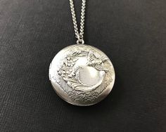 Antique Silver Bird Floral Locket.... I have attached an antique silver bird and floral brass stamping to a beautiful floral antique silver brass locket. The locket is suspended from a high quality antique silver rolo chain with soldered links. The chain closes with a lobster claw clasp. This sweet bird locket looks even better in person! It will be sent to you gift wrapped. A great gift to give your wife, girlfriend, best friend, grandmother or mom on Valentine's Day or a special occasion! Give Wedding Locket Necklace In Metal, Wedding Metal Locket Necklace, Engraved Metal Locket Necklace For Wedding, Engraved Silver Jewelry For Vintage Events, Antique Silver Locket Necklace For Wedding, Vintage Adjustable Locket Necklace For Wedding, Nickel-free Silver Locket Necklace For Wedding, Nickel Free Silver Locket Necklace For Wedding, Ornate Stamped Jewelry For Wedding