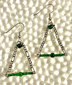 Triangular wire structure with glass beads and an ear wire. Green Metal Beaded Party Earrings, Wire Wrapped Metal Earrings For Party, Green Metal Beaded Earrings For Party, Party Wire Wrapped Metal Earrings, Pierced Metal Beaded Earrings For Party, Metal Beaded Earrings For Party, Nickel-free Czech Glass Beaded Earrings For Parties, Nickel Free Czech Glass Beaded Earrings For Party, Nickel-free Metal Beaded Earrings For Party