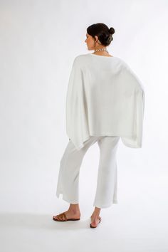 This versatile poncho features a V-neck and an elegant drape, making it the perfect complement to any top or dress. An ideal addition to your wardrobe for all seasons, it's crafted from a soft blend of 70% Merino Wool and 30% Acrylic. Click Here for Care Instructions Elegant Drapes, Beautiful Drapes, Essential Bag, Linen Clothes, All Seasons, Nightwear, One Size Fits All, Lay Flat, Merino Wool