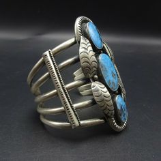 "VINTAGE NAVAJO BRACELET DESCRIPTION: This cuff features three exquisite specimens of high blue Kingman Birdseye turquoise. The gemstones are secure in smooth bezel, on a foundation of heavy gauge vintage sterling silver. Applied leaves and chisel-stamped designs enhance the face of the cuff. This extraordinary bracelet will be a cherished addition to your collection of fine vintage Native American jewelry. MEASUREMENTS: Interior of the cuff measures 5 1/4\" with an additional 1 1/2\" slightly a Jewelry Measurements, Bones Bracelet, Vintage Native American Jewelry, Navajo Bracelet, Turquoise Bracelet Cuff, Turquoise Cuff, Vintage Navajo, Coral Turquoise, Denver Co