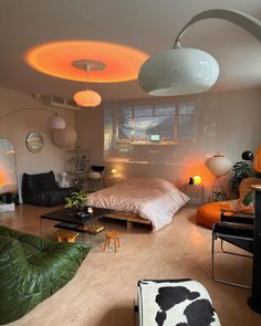 a bedroom with an unusual ceiling light above the bed and other furniture in front of it