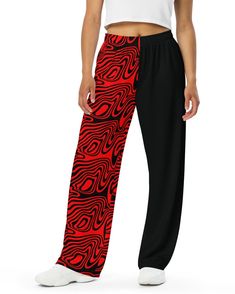 Get ready to rave in ultimate comfort with the Hypnotic Split Wide Leg Pants. These pants bring all the chill vibes of your favorite sweatpants but with way more style. Featuring a bold red and black split design with trippy wavy patterns on one leg, these pants are perfect for making a statement at Lost Lands, Bass Canyon, or your next rave. Relaxed unisex fit for all-day comfort, whether you're dancing or lounging Handy side pockets to stash your essentials while you vibe out Elastic waistband Red Wide Leg Sweatpants With Elastic Waistband, Red Wide Leg Sweatpants For Streetwear, Casual Red Wide Leg Sweatpants, Trendy Red Pants With Elastic Waistband, Trendy Red Loungewear Bottoms, Edgy Red Pants For Streetwear, Casual Red Summer Sweatpants, Edgy Black Bottoms For Loungewear, Trendy Red Sweatpants For Streetwear