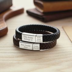 "This bracelet is engraved with the phrase WE LOVE YOU DADDY, BEST DADDY EVER, THIS DADDY BELONGS TO on large clasp, and the baby's name on the smaller clasp. But you can also personalize this clasp of the bracelet with any custom phrase, making it perfect as Gift for Dad. P R O D U C T ∙ I N F O * Materials: 2 stainless steel magnetic clasps & PU leather cord.  * Clasps size are approx 15/16'' x 3/8'' and 3/8'' x 3/8''  * Word limits: 5-7 words for loong side / 2-3 words for short side * Sizing: Please kindly note that this bracelet design can't be adjustable. Make sure to measure your wrist and choose the right size before ordering. Our sizing chart is as follows: Size S: inside circumference 6 1/4 inches (16cm) - suitable for 5 1/2 - 6 1/3 inches (14-16cm) Size M: inside circumference 7 Engraved Rectangular Bracelet As A Gift, Engraved Rectangular Bracelets As Gifts, Engraved Rectangular Bracelet As Gift, Rectangular Engraved Bracelet As A Gift, Adjustable Engraved Rectangular Bracelet, Silver Engraved Leather Bracelet For Anniversary, Rectangular Engraved Adjustable Bracelets, Adjustable Rectangular Engraved Bracelet, Anniversary Engraved Silver Leather Bracelet