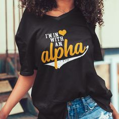 "Custom & Vintage Alphas Fraternity Graphic Tees, Hoodies, Sweatshirts, and More Alabama State Apparel For Both Alpha Phi Alpha Ice Cold Brothas and Men of Distinction Alumni. Black owned, HBCU alumni operated apparel company specializing in academic wear. This Alphas Fraternity product is handmade in Atlanta, GA with materials purchased from local Atlanta vendors. We use only the best material, printing, and packaging. Orders typically ship much faster than posted timeframes. We Use Bella + Canvas (B6400) 100% Ringspun Cotton and Gildan (G500) 100% Cotton Shirts. Gildan is the default for every item. We've ensured that both models are the same width, length, and chest. There are dozens of models for each brand but those two are the most consistent across the board in look and feel. All Un Black Slogan Fan Apparel Top, Black Slogan Top Fan Apparel, Black Slogan Top For Fan Apparel, Black Slogan Tops For Fans, Black Fan Apparel T-shirt With Lettering, Black T-shirt With Lettering For Fans, Alpha Fraternity, Packaging Orders, Alpha Phi Alpha