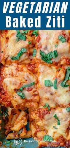 vegetarian baked ziti in a blue casserole dish with fresh basil on top