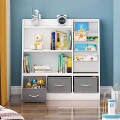 a white book shelf filled with books and storage bins next to a blue wall