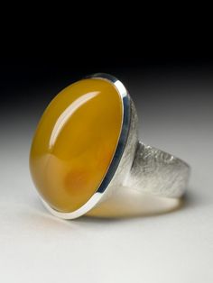 Big scratched silver ring with natural cabochon cut Carnelian stone measurements - 0.51 x 0.55 x 0.87 in / 13 x 14 x 22 mm stone weight - 25.4 carats ring size - 9.25 US / 60 EU / 19.25 ring weight - 13.28 grams ref No 5307 Worldwide shipping from Berlin, Germany Modernist Round Cabochon Jewelry, Modern Carnelian Jewelry With Polished Finish, Modern Chalcedony Jewelry With Polished Finish, Polished Agate Oval Cabochon Rings, Modern Oval Cabochon Jewelry With Large Stone, Oval Cabochon Agate Ring With Polished Finish, Modernist Oval Cabochon Rings, Oval Amber Agate Ring, Amber Agate Cabochon Ring