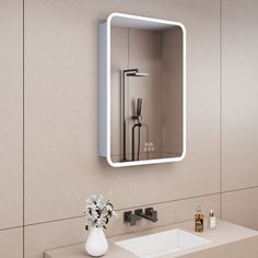 a bathroom with a sink, mirror and hair dryer on the wall above it