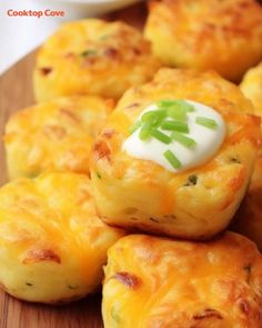 small cheesy potatoes on a wooden cutting board