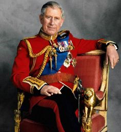 an older man in a red uniform sitting on a gold chair with his arms crossed