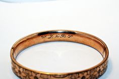 Antique gold filled bangle bracelet, circa 1911. In good condition, with minor wear commensurate to age. Antique Gold Stamped Bracelets, Antique Gold Bracelets Stamped, Antique Gold Bracelets With Stamped Details, Antique 14k Gold Bangle, Vintage Etched Gold Bangle Bracelet, Vintage Gold Stamped Bangle, Antique Engraved Round Bracelets, Victorian Engraved Gold Bracelet, Vintage Etched Gold Bracelet For Wedding