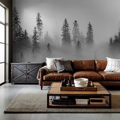 a living room with a couch, coffee table and wall mural