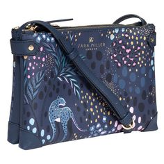 Sara Miller Midnight Tahiti Leopard Zip Crossbody Bag
This stunning stylish bag from Pelham Leather makes the ideal accessory from day to evening. Showcasing the magnificent ‘Tahiti’ design by Sara Miller, it depicts sleek and slender leopards roaming through a midnight setting, camouflaged with iconic spotted prints and foliage. This is all set against a sophisticated deep blue background.
This fabulous crossbody bag is made from durable yet luxurious saffiano fabric. The handbag features a long adjustable, shoulder strap for carrying on one shoulder or across your body, leaving you completely hands free to go about your day. This bag features multiple compartments, including two large zip compartments that are each fully lined with a contrasting soft-pink fabric with leaf pattern. One of Sara Miller, Evening Accessories, Embossed Fabric, Silk Eye Mask, Large Cosmetic Bag, Leopard Design, Zip Purse, Pink Leaves, Embroidered Cushions