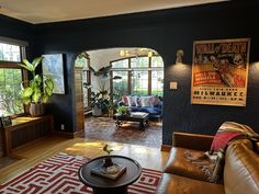 a living room filled with furniture and lots of windows