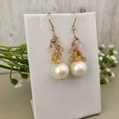 Gorgeous freshwater Pearl Drop Earrings. They are perfect in their simplicity and are incredibly elegant. There is a great deal of detail in these earrings, as you would expect from a Praha Jewelry Design piece. Description: 15mm white round pearls are suspended by 14K GF chain with pastel sapphire briollets. 2mm 14K GF seamless balls sit just above each briollet. All 14K GF and 24K vermeil components Elegant Hypoallergenic Briolette Earrings, Briolette High Luster Pearl Earrings As Gift, Briolette High Luster Pearl Earrings For Gift, High Luster Briolette Pearl Earrings As Gift, High Luster Briolette Pearl Earrings For Gift, Akoya Pearl Dangle Earrings In Pearl White, Pearl White Akoya Pearl Dangle Earrings, Akoya Pearl Dangle Earrings For Anniversary, Akoya Pearl White Dangle Earrings