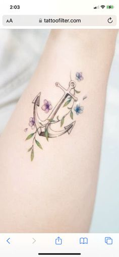 an anchor with flowers on the side of her leg is shown in this tattoo artist's instagram