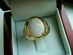 an opalite ring sits in a box