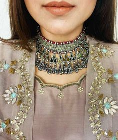 Antique finish jewelry crafted in mixed metal, with colorful stones inlay surrounded with ghungroos is pure bliss. adding a lot of drama, with embossing motifs, mirrors, stones & in playful ghungroo danglers, our Afghani choker Necklace can be paired with any outfit. Luxury Mirror Work Necklaces For Festivals, Festive Dual-tone Metal Necklaces, Festive Dual-tone Metal Necklace, Kundan Necklace With Oxidized Finish For Celebration, Dual-tone Silver Jewelry Sets For Festivals, Dual-tone Silver Jewelry For Festivals, Silver Dual-tone Jewelry Sets, Silver Dual-tone Jewelry For Festivals, Dual-tone Metal Necklace For Celebration