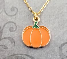 "This listing is for an orange pumpkin pendant necklace. You'll be able to choose your chain length and style at checkout by using the \"Chain Length/Style\" drop-down menu. Keyrings, bangle bracelets, ball chains, and black/brown leather and suede cord are also available. **Please see the second photo for scale! If you're on the mobile site, just swipe to the side. :) ITEM CARE: We recommend avoiding contact with water or moisture of any kind, for best results. - - - - - - - Sign up for our newsletter to receive coupons and updates on new items! Follow the link: ♦ ♦ ♦ http://eepurl.com/cG7GGT ♦ ♦ ♦ - - - - - - - This is our third shop for jewelry. If you're looking for something a bit more \"personalized\", then just follow these links: www.etsy.com/shop/metalspeak www.etsy.com/shop/metal Pumpkin Necklace Diy, Spooky Orange Jewelry For Gifts, Halloween Charm Necklace, Orange Novelty Halloween Jewelry, Pumpkin Necklace, Small Pumpkins, Suede Cord, Halloween Jewelry, Fall Jewelry