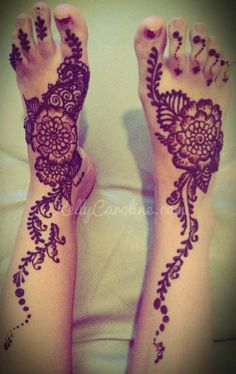 two feet with henna tattoos on them, one is purple and the other is white