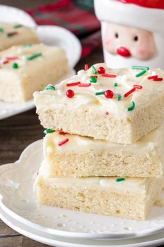 three pieces of cake on a plate with white frosting and sprinkles