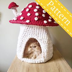 a cat in a crocheted mushroom house with the words pattern below it that says,