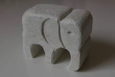 an elephant made out of white clay sitting on a table