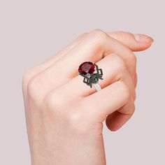 Perfect for Halloween, and cool all year long, our spider ring in Hug Me® collection is an edgy pick! This fabulous spider has long been a symbol of creativity and is seen as the master of it's own destiny. Crafted in sterling silver, this ring features a shimmering red round-cut stone hugged by a black spider. You will find more adorable and creative designs in our Hug Me® collection.Carat Weight: 6.46 ctStone Size: 10 mmStone Type: Jeulia® StoneNumber of Stones: 1 Stone Shape: RoundStone Color: Garnet RedCarat Weight: 0.057 ctStone Size: 1.5 mmStone Type: Jeulia® StoneNumber of Stones: 2 Stone Shape: RoundStone Color: Diamond WhiteWeight: 6.12 gMaterial: 925 SilverPlating Color: Silver, Black Widow Spider, Black Widow Spider, Black Spider, Cute Box, Hug Me, Pretty Rings, Black Widow, Anniversary Sale, Red Garnet