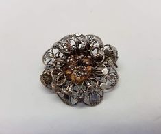 Very pretty vintage filigree flower brooch in 800 silver. The flower shape is beautifully designed in silver, though I cannot find any markings on the brooch, it does test positive for sterling, so it is at least 800 silver. This is a 40's-50's piece and is still in such great condition, it simply needs a good cleaning/polishing. This piece would make a terrific gift for a vintage jewelry lover. I'll ensure your order is fulfilled as requested. Visit my shop at: newagainclassics.ca -Shipping tim Vintage Sterling Silver Flower Brooches, Silver Flower Shaped Brooch Jewelry, Silver Floral Brooch, Silver Flower Shaped Brooch, Silver Floral Shape Brooch Jewelry, Handmade Silver Jewelry For Vintage Events, Vintage Filigree Flower Jewelry, Victorian Silver Brooch For Vintage Events, Vintage Silver Flower Brooches