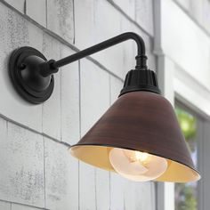 Our mid-century style metal shade wall light is perfect for a modern farmhouse; retro kitchen or porch. Features a globe LED bulb and painted shade mounted on an angled arm. This light fixture can be used either indoors or outdoors; and is suitable for hospitality projects. JONATHAN Y Croydon Iron Gooseneck Arm Industrial Farmhouse 1-Light 15-in H Satin Brown LED Outdoor Wall Light | JYL7612G Farmhouse Wall Lighting, Porch Kitchen, Wall Mount Lantern, Shade Wall, Farmhouse Industrial, Black Outdoor Wall Lights, A Globe, Led Outdoor Wall Lights, Outdoor Sconces