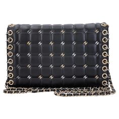 Store item: 67544 This Pristine Chanel 16B Punk CC-Studded Piercing Clutch on Chain Bag Black is a collector's piece in pristine, like-new condition. From 2016. In "chocolate bar" square quilts, small CC studs in dark ruthenium, silver and gold, with multiple piercings along the edge of the bag, a long crossbody woven chain strap that can be tucked inside as a versatile clutch. This is considered a special release by Chanel, and hence the gold bar plaque inside instead of a leather patch label, Chanel Clutch With Chain 2022, Party Leather Shoulder Bag With Metal Logo, Rectangular Office Shoulder Bag With Metal Logo, Luxury Studded Shoulder Bag, Luxury Studded Bags For Party, Black Studded Shoulder Bag For Party, Chic Black Studded Shoulder Bag, Elegant Rectangular Studded Shoulder Bag, Designer Party Bags With Metal Logo