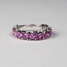 an image of a ring with pink stones on it