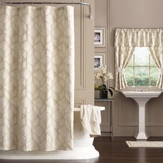 a white shower curtain in a bathroom next to a sink