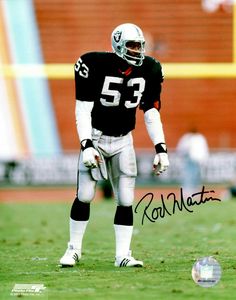 an autographed photograph of a football player on the field with a ball in his hand